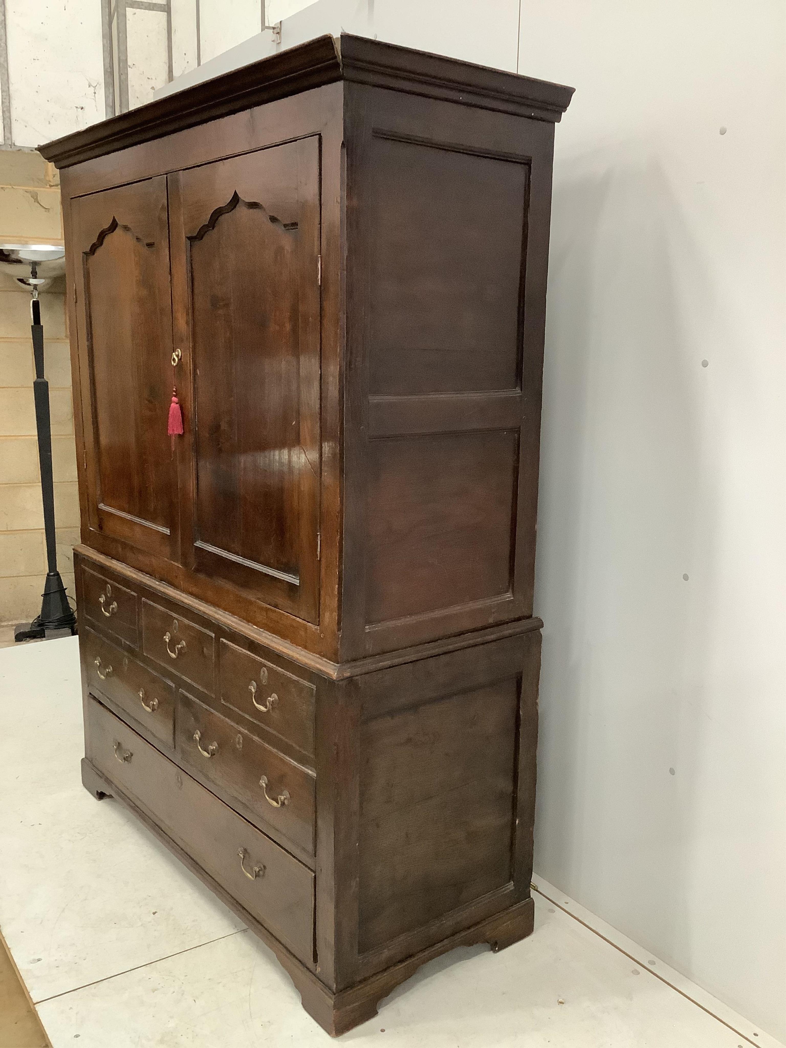 An early 18th century and later oak press cupboard with two doors and one base drawer, width 140cm, height 185cm. Condition - fair to good